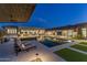 Beautiful backyard with a pool, outdoor kitchen, covered patio, and ample seating at 9456 E Sands Dr, Scottsdale, AZ 85255