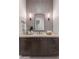 Stylish bathroom featuring modern fixtures, a decorative mirror, and elegant vertical accent wall tiling at 9456 E Sands Dr, Scottsdale, AZ 85255