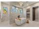 Elegant bathroom featuring soaking tub, marble accents, and a seamless glass shower at 9456 E Sands Dr, Scottsdale, AZ 85255