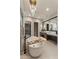 Bright bathroom featuring a soaking tub, dual vanities, and a modern chandelier at 9456 E Sands Dr, Scottsdale, AZ 85255