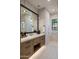 Stylish bathroom vanity featuring undermount sink, quartz countertop, and framed mirror at 9456 E Sands Dr, Scottsdale, AZ 85255