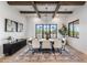 Beautiful dining room featuring wood-beam ceilings, black frame windows, and decorative furnishings at 9456 E Sands Dr, Scottsdale, AZ 85255
