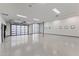 Spacious garage with epoxy flooring, bright lighting, and multiple glass panel doors at 9456 E Sands Dr, Scottsdale, AZ 85255