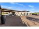 A long paved driveway leads to garages with steel doors and an entry gate at 9456 E Sands Dr, Scottsdale, AZ 85255