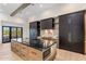 Stylish kitchen featuring a large island with dark countertops, custom cabinetry, and hardwood flooring at 9456 E Sands Dr, Scottsdale, AZ 85255