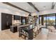 Spacious kitchen with black marble counters, light wood floors, and pendant lighting, perfect for entertaining at 9456 E Sands Dr, Scottsdale, AZ 85255