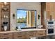 Modern kitchen showcasing custom cabinets and a picturesque view of the sparkling pool at 9456 E Sands Dr, Scottsdale, AZ 85255