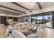 Spacious living room flowing into the kitchen and providing views of the backyard pool at 9456 E Sands Dr, Scottsdale, AZ 85255
