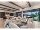 Spacious living room flowing into the kitchen and providing views of the backyard pool at 9456 E Sands Dr, Scottsdale, AZ 85255
