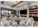 Cozy living room with a fireplace, built-in shelves, recessed lighting, and sliding glass doors at 9456 E Sands Dr, Scottsdale, AZ 85255