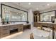A spa-like bathroom with double vanities, soaking tub and walk-in shower at 9456 E Sands Dr, Scottsdale, AZ 85255