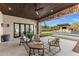 Outdoor patio featuring comfortable seating, ceiling fan, and scenic pool view at 9456 E Sands Dr, Scottsdale, AZ 85255