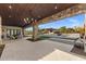 Stunning patio featuring a stone column, wood ceiling, and view of the pool and cabana at 9456 E Sands Dr, Scottsdale, AZ 85255