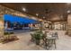Spacious stone patio with a seating area overlooking the pool, fire pit and backyard at 9456 E Sands Dr, Scottsdale, AZ 85255
