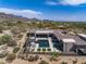 A beautiful pool with a spa is surrounded by desert landscaping at this house at 9456 E Sands Dr, Scottsdale, AZ 85255
