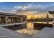 Luxury home featuring a modern pool with desert landscape backdrop at 9456 E Sands Dr, Scottsdale, AZ 85255
