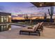 Relaxing pool area with lounge chairs, integrated spa, and stunning sunset views of the desert landscape at 9456 E Sands Dr, Scottsdale, AZ 85255