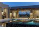 Luxury pool with mountain views seen through the open air patio with an elegant chandelier at 9456 E Sands Dr, Scottsdale, AZ 85255