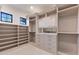Walk-in closet features custom shelving, drawers, and cabinets at 9456 E Sands Dr, Scottsdale, AZ 85255