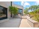 Beautiful backyard with tiered landscaping, a stone walkway, and desert foliage at 10040 E Happy Valley Rd # 243, Scottsdale, AZ 85255