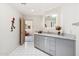 Modern bathroom with granite countertop vanity, stylish light fixtures, and tile flooring at 10040 E Happy Valley Rd # 243, Scottsdale, AZ 85255