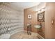 Stylish powder room featuring decorative tile accents and a unique vessel sink on a glass stand at 10040 E Happy Valley Rd # 243, Scottsdale, AZ 85255