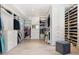An expansive walk-in closet showcases custom shelving, storage solutions, and ample space for clothing at 10040 E Happy Valley Rd # 243, Scottsdale, AZ 85255