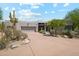 Desert landscaping compliments the home's exterior elevation, and front entry at 10040 E Happy Valley Rd # 243, Scottsdale, AZ 85255