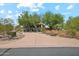 Mature trees surround a circular driveway that leads to the home at 10040 E Happy Valley Rd # 243, Scottsdale, AZ 85255