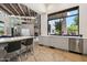 Bright kitchen featuring sleek cabinets, stone floors, and a view to the living area with rustic wood-beamed ceilings at 10040 E Happy Valley Rd # 243, Scottsdale, AZ 85255