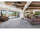 Upstairs living area showcasing wood-beamed ceilings, a cozy seating area, and desert scenery at 10040 E Happy Valley Rd # 243, Scottsdale, AZ 85255