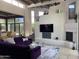 Bright living room features fireplace, TV, and large windows showcasing natural lighting at 10040 E Happy Valley Rd # 243, Scottsdale, AZ 85255