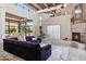 Open living room boasts beamed ceilings, fireplace, and large glass windows at 10040 E Happy Valley Rd # 243, Scottsdale, AZ 85255