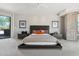 This main bedroom features a king bed, ceiling fan, sliding door access, and contemporary design at 10040 E Happy Valley Rd # 243, Scottsdale, AZ 85255