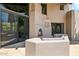 Outdoor patio with stone-clad fireplace, built-in seating, and sliding glass doors at 10040 E Happy Valley Rd # 243, Scottsdale, AZ 85255