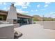 Rooftop patio featuring an outdoor fireplace with panoramic views of the desert landscape at 10040 E Happy Valley Rd # 243, Scottsdale, AZ 85255