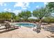 Stunning backyard featuring a pool with lounge chairs and dining table with views of mature landscaping at 10040 E Happy Valley Rd # 243, Scottsdale, AZ 85255