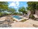 Backyard oasis featuring a sparkling pool, spa, and patio seating, surrounded by lush desert landscaping at 10040 E Happy Valley Rd # 243, Scottsdale, AZ 85255