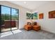A vibrant seating area features sliding glass doors and views of the surrounding trees and landscape at 10040 E Happy Valley Rd # 243, Scottsdale, AZ 85255