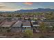 Scenic aerial view of a desert community at sunset with mountain views and single Gathering homes at 10775 E Peralta Canyon Dr, Gold Canyon, AZ 85118