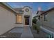 Cozy home entrance with decorative embellishments around the door complemented by desert landscaping and subtle lighting at 10775 E Peralta Canyon Dr, Gold Canyon, AZ 85118