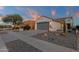 Charming home featuring desert landscaping, stylish garage door, and decorative exterior lighting at 10775 E Peralta Canyon Dr, Gold Canyon, AZ 85118