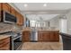 Stylish kitchen featuring stainless steel appliances, granite countertops and dark wood cabinets at 10775 E Peralta Canyon Dr, Gold Canyon, AZ 85118