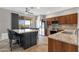 Well-appointed kitchen with granite countertops, stainless steel appliances, and a kitchen island with seating at 10775 E Peralta Canyon Dr, Gold Canyon, AZ 85118