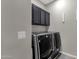 Laundry area with modern LG washer and dryer and overhead cabinets at 10775 E Peralta Canyon Dr, Gold Canyon, AZ 85118
