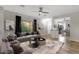 A modern living room featuring neutral walls, dark curtains, stylish furniture, and an open floor plan at 10775 E Peralta Canyon Dr, Gold Canyon, AZ 85118
