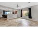 Inviting living room featuring tile floors, neutral paint, and an open layout to the kitchen and bright window at 10775 E Peralta Canyon Dr, Gold Canyon, AZ 85118