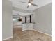 Open living space with tile floors, neutral paint, and a kitchen view, creating an airy and connected atmosphere at 10775 E Peralta Canyon Dr, Gold Canyon, AZ 85118