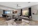 Open-concept living room with tile flooring, ceiling fan, and access to dining and kitchen area at 10775 E Peralta Canyon Dr, Gold Canyon, AZ 85118