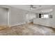 Spacious living room with tiled floor, neutral paint, and partial wall view to the kitchen area at 10775 E Peralta Canyon Dr, Gold Canyon, AZ 85118